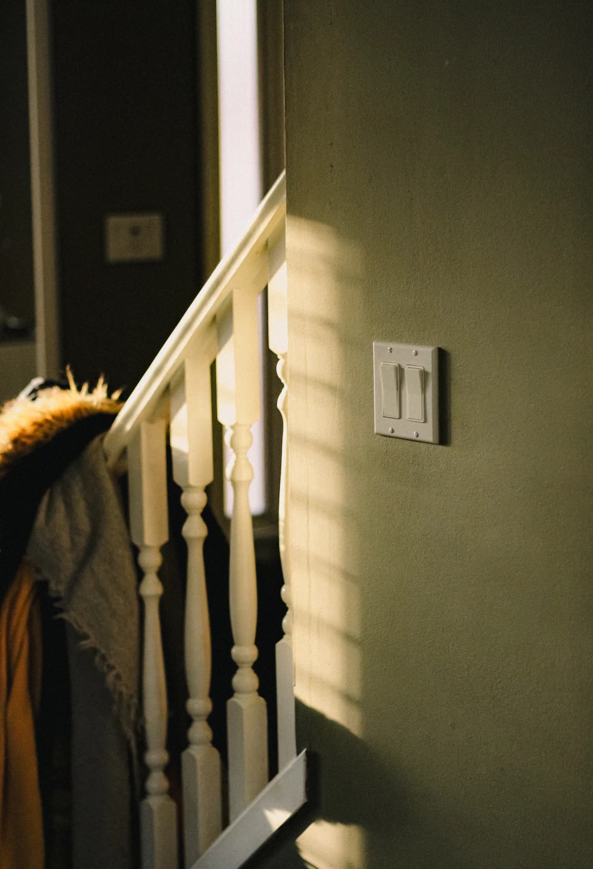 Warm connected-living interior with a discreet wall control