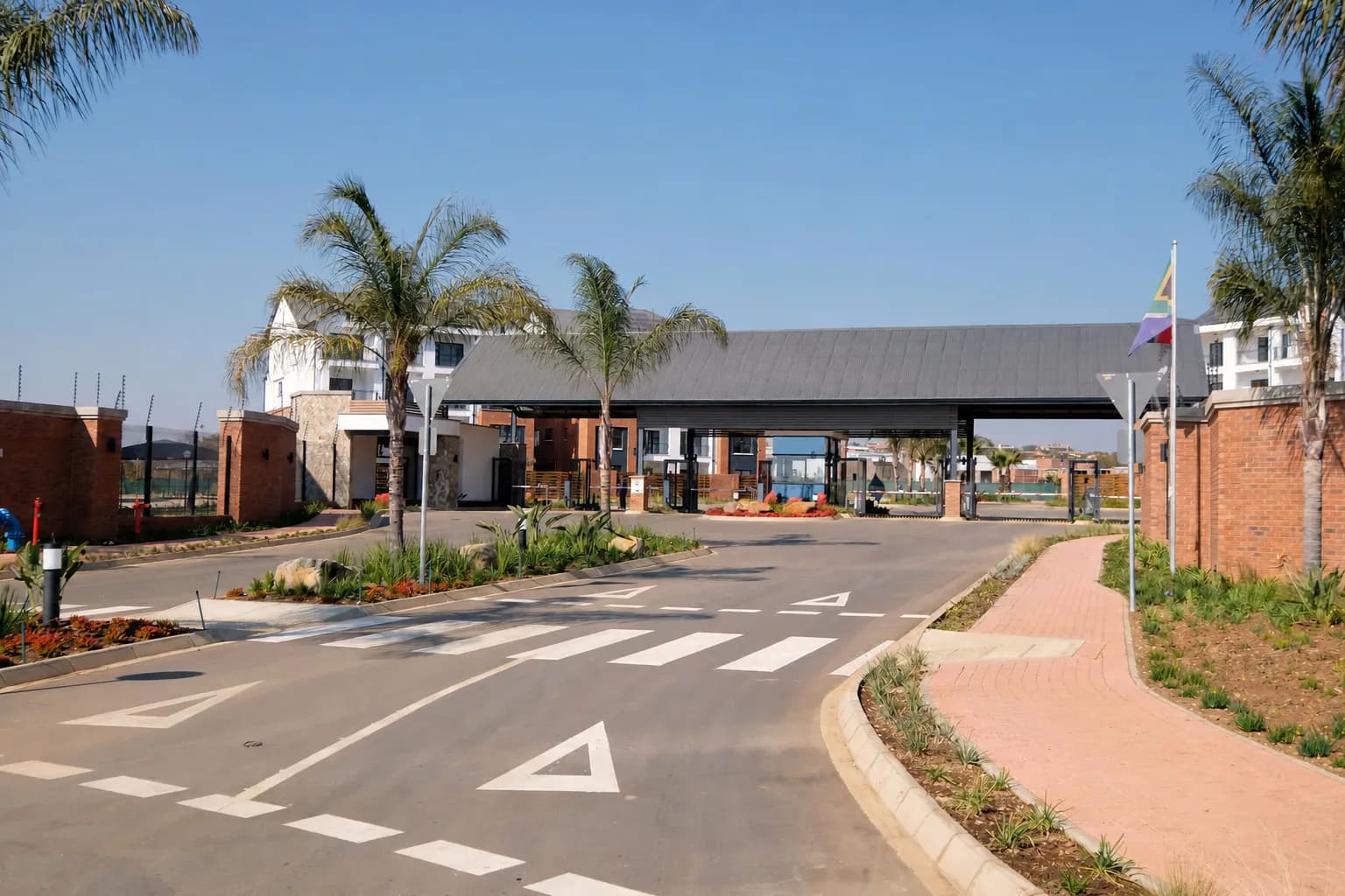 Landscaped gated residential community entrance with controlled vehicle access